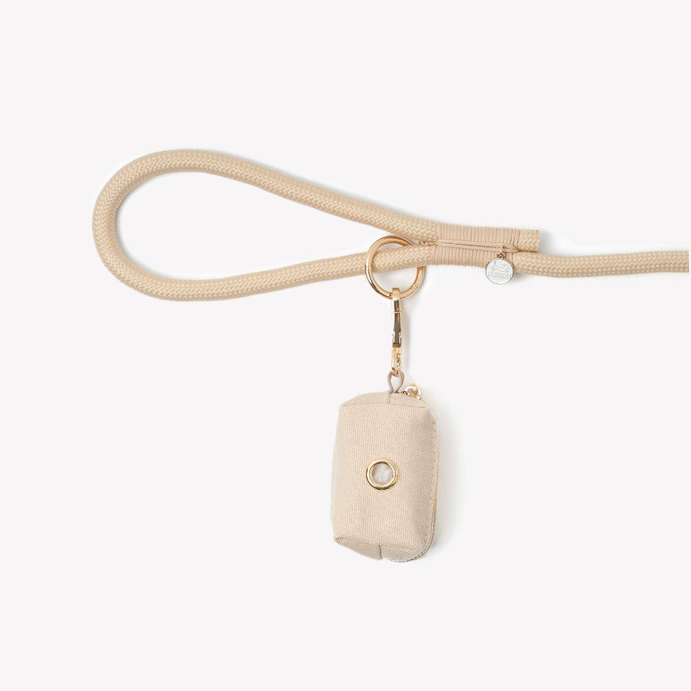 Beige handbag with a matching strap on a white background