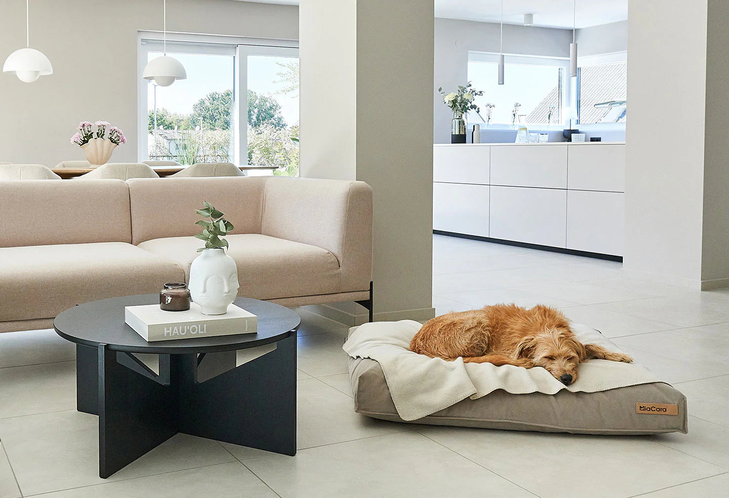 large terrier sleeping on beige miacara dog blanket in a moden home
