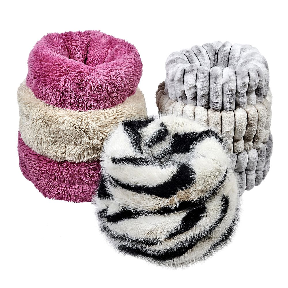 Four fluffy small dog beds in pink, beige, gray, and black and white pattern on a white background